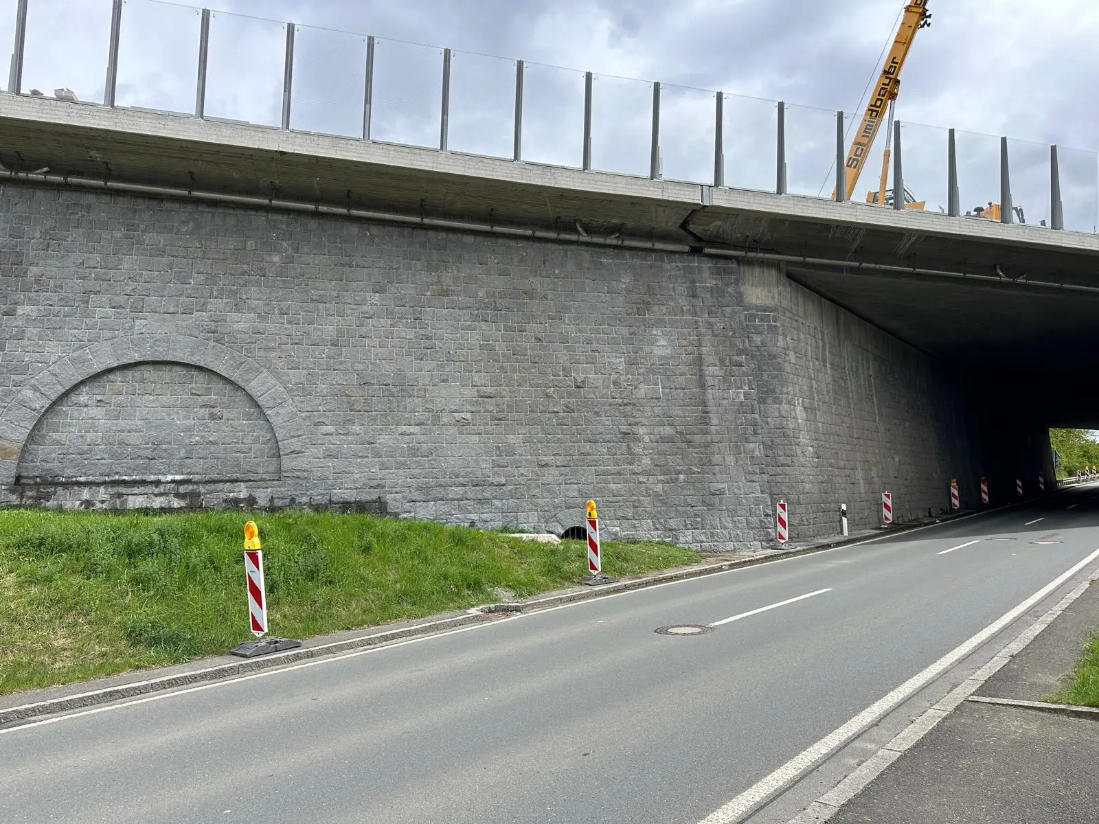 Cleaned natural stone facade of a bridge structure after specialized cleaning
