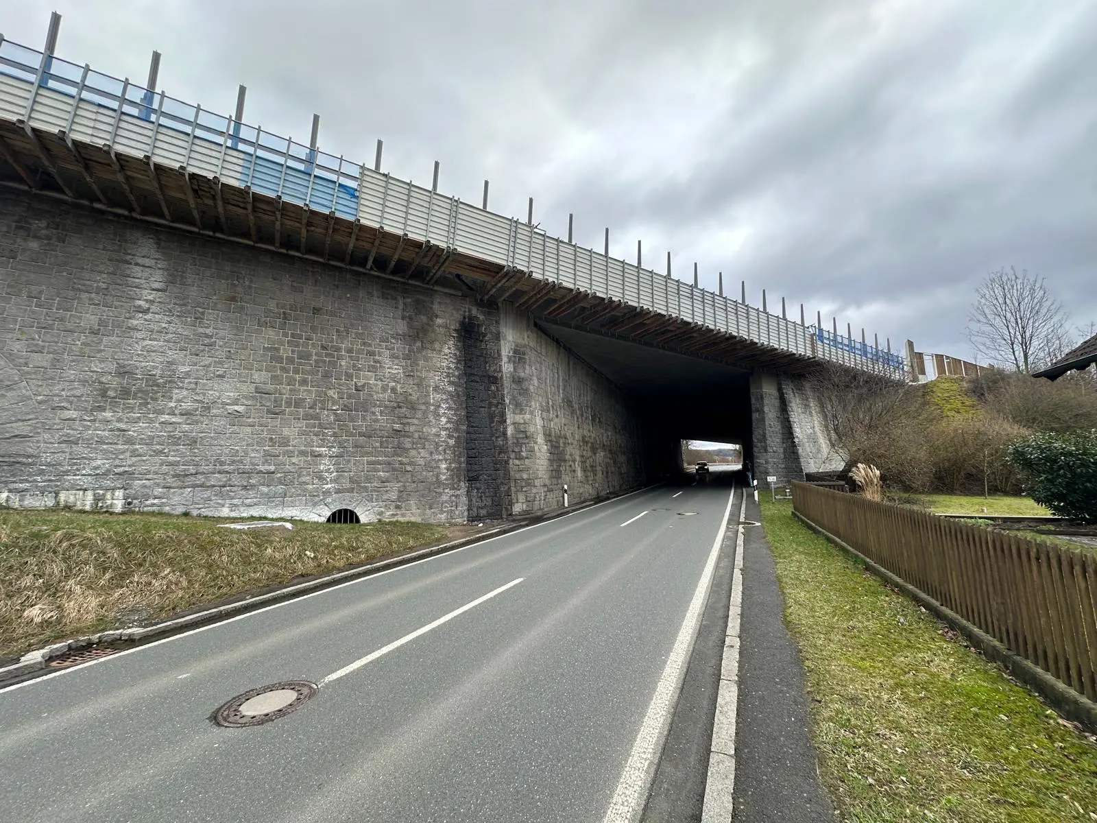 Bridge structure with contaminated natural stone facade before specialized cleaning