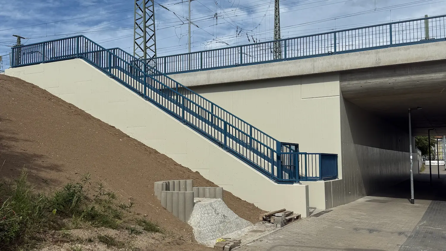 Repaired concrete area at a railway underpass in Rostock with refinished wall surface and stairway