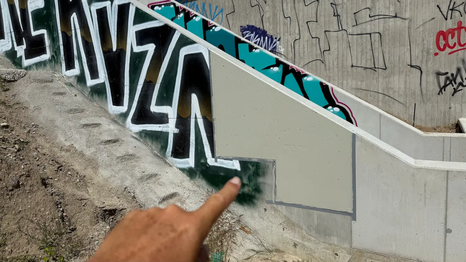 Partially refinished concrete surface during concrete repair and graffiti protection treatment in Rostock