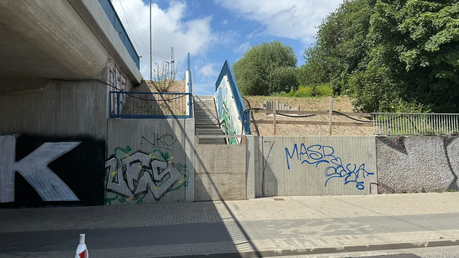 Concrete surfaces covered with graffiti at a stairway in Rostock before concrete repair