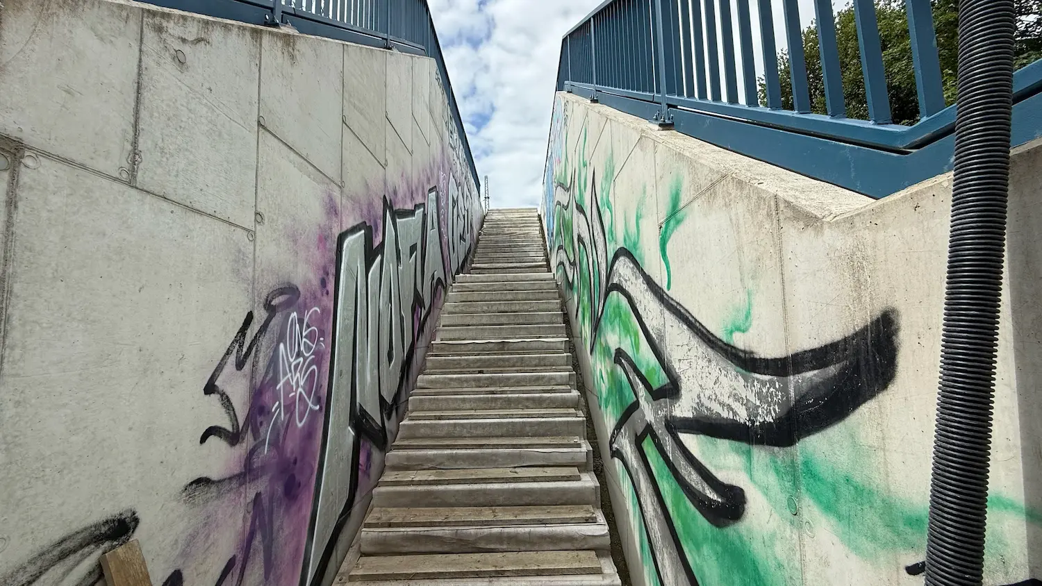 Concrete walls covered with graffiti at a stairway before concrete repair in Rostock