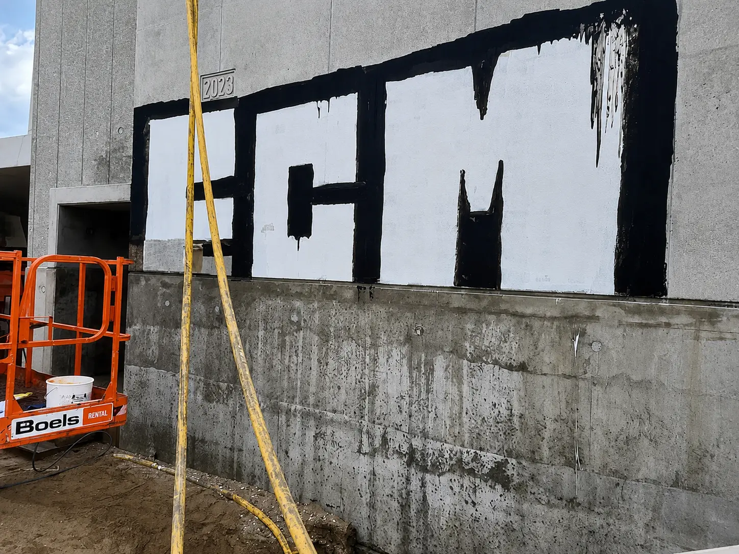 Concrete wall with large-scale graffiti before professional graffiti removal by Muschert.